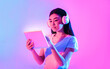 © Prostock-studio - Modern devices. Asian woman working on tablet with wireless headphones