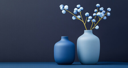 Sticker - Elegant matte ceramic vases in gray-blue and vibrant blue with decorative branches on navy surface