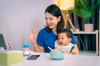 © SKW - Asian women are working from home and raising their young children.