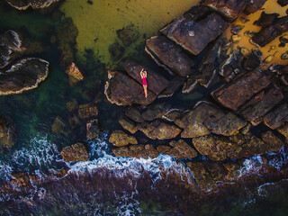 Girl in a boat on the beach top view. Aerial photography