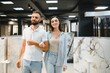 © Serhii - Married couple chooses ceramic tiles for kitchen or bath at a hardware store