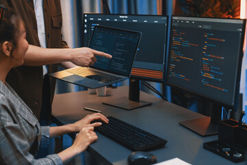 Wall Mural - serious of it developers discussing intelligent website development coder system running data online