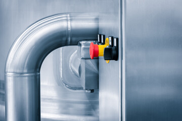 Poster - Dairy machine cooling radiator with a row of stainless steel metal pipes with silver trim. The pipes are connected to each other and appear to be part of a larger system