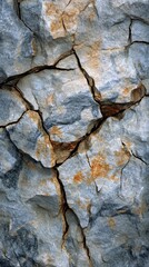 Wall Mural - a rock with a crack in it. the crack is long and deep. the rock is grey and brown