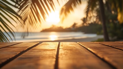 Poster - empty wooden table with a tropical beach background featuring palm leaves and a golden sunset, ideal