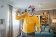 © Miljan Živković - man mature senior male at home enjoy virtual reality VR headset