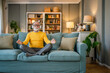 © Miljan Živković - Mature senior man practice guided meditation manifestation at home