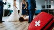 © Sam - A dramatic scene at a wedding with a fallen bride, first aid kit in focus, and wedding guests in background.
