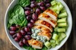 © LimeSky - Top down view of a white plate featuring a salad of chicken spinach celery grapes and Gorgonzola