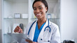 © Ozgurluk Design - Smiling Female Doctor Holding Clipboard in Clinic