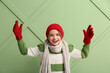 © Pixel-Shot - Cute little happy boy in winter clothes on green background