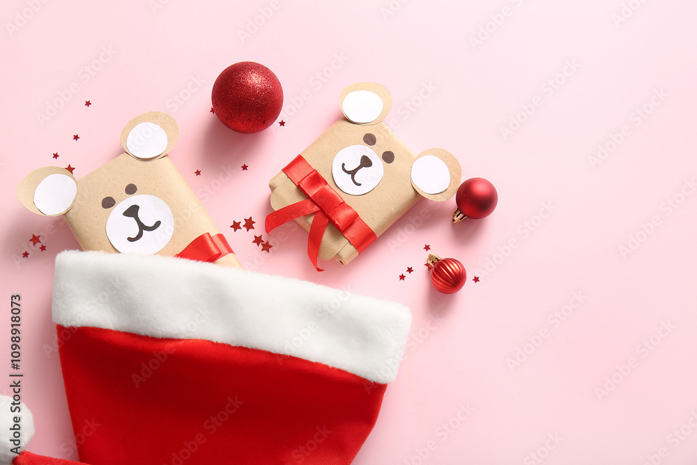 Beautiful composition with Santa hat, gift boxes and Christmas balls on pink background