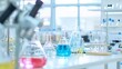 © JuliaDorian - Laboratory Glassware with Blue Liquid Solution, Research, and Development. Background Copy Space.