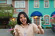 © M Alfan Setyawan - cheerful young asian woman holding sparkler to celebrate new year eve with garden party standing over colorful vintage house yard
