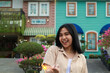 © M Alfan Setyawan - portrait of beautiful happy young asian woman holding sparklers fireworks to celebrate new year eve with garden party standing in outdoor vintage house yard