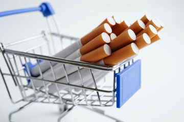 Cigarette in shopping cart, cost, trading, marketing and production, No smoking concept.