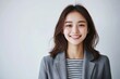 © Ganesha88 - Young Japanese woman in business casual attire, smiling and looking directly at the camera with confidence against  Portrait of a professional office worker  confident young entrepreneur on isolated