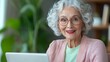 © AIMAN - Elderly woman engages in video conferencing cozy living room inspirational moment indoor setting heartwarming connection technology use