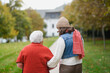 © Halfpoint - Rear view of a granddaughter on an autumn walk in the park with her grandmother.