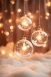 © DSimage - Two shimmering glass ornaments dangle from a delicate string, glowing softly against a backdrop of twinkling Christmas lights, creating a magical festive atmosphere.