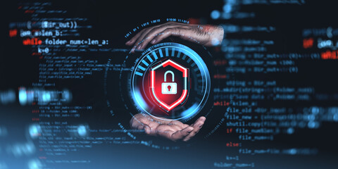 hands holding a digital padlock shield in a futuristic interface with code background.