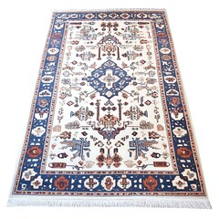 Wall Mural - A Persian rug with an intricate geometric pattern in cream, blue, and red hues. The design features traditional motifs like floral designs and stylized animals, all arranged to create symmetrical