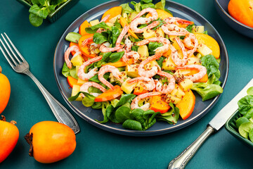 Wall Mural - Seafood shrimp persimmon salad on white plate.