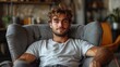 ©  Dreamy Shots - Young man sitting relaxed in armchair, casual living room setting, cozy atmosphere, contemplative expression, peaceful indoor portrait, warm light, comfortable