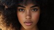 © VRVisionary - Close up portrait of a stunning young woman with afro hair gazing directly at the camera