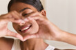 © puhhha - Dental Care. Close-up Of Smiling Woman Creating Heart Shape With Hands, Exuding Joy And Positivity. Captures Self-Love And Happiness, Highlighting Healthy Teeth And Natural Beauty.