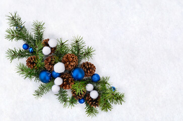 Wall Mural - christmas decoration. blue christmas balls, cones pine, branches christmas tree on snow with space f