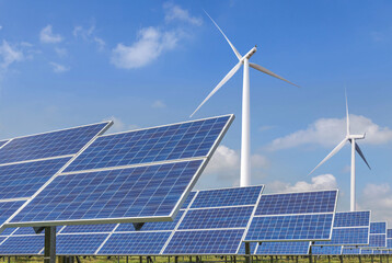 Wall Mural - Rows array of Solar panels and wind turbines generating electricity in hybrid power plant systems station , alternative clean energy renewable efficiency