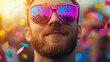 © pattaphorn - A vibrant atmosphere featuring a man in colorful sunglasses, enjoying a festive moment surrounded by confetti and cheerful crowds.