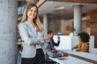 © Dragana Gordic - Confident Businesswoman Leading Team in Modern Office Setting