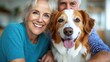 © LifeMedia - An elderly couple sharing a joyful moment with their dog; both the couple and the dog display cheerful expressions of contentment, embodying love and companionship.