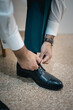 © Zekker - man tying his shoes
