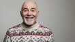 © Natsumae - Joyful senior man smiles warmly in a festive holiday sweater.  A heartwarming winter portrait.