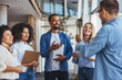 © Dragana Gordic - Happy Professionals Engaged in a Lively Office Discussion