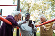 © Marko Geber - Senior friends taking a selfie after a group workout at an outdoor park