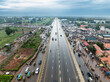 © AmazingAerialAgency - Aerial view of a bustling highway with traffic and vibrant cityscape, Kaduna North, Nigeria.