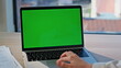 © stockbusters - Programmer hand working laptop with green screen closeup. Unknown businesswoman