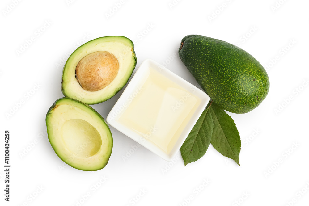 Fresh avocados and bowl with essential oil on white background