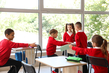 Wall Mural - Little pupils having lesson in classroom