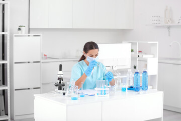 Sticker - Female young scientist with professional glassware examining water quality in research laboratory