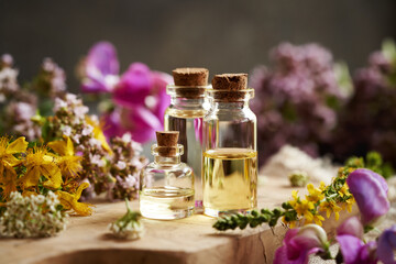 Wall Mural - Bottles of aromatherapy essential oil with summer flowers