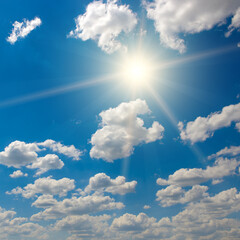 Wall Mural - bright sun on beautiful blue sky with white clouds.