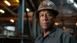 © MD Media - African American construction architect surveyor manager foreman worker wearing a hard hat in a warehouse factory
