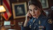 © YURY YUTY - A military officer in uniform speaks on the phone at a desk with a flag in the background.