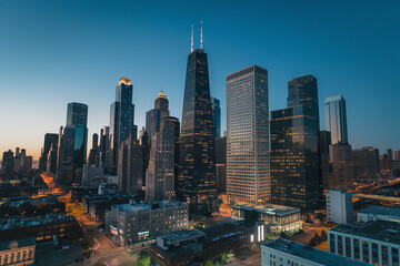 Skyline of a bustling city illuminated at dusk, showcasing modern architecture and vibrant city life