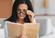 © Prostock-studio - Portrait of confused senior woman squinting to see more clearly, wearing and touching eyeglasses, trying to read paper book, having difficulties seeing text because of bad vision problems and issues